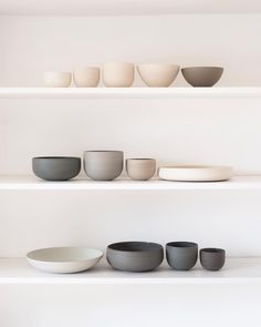 white shelves with bowls and plates on them