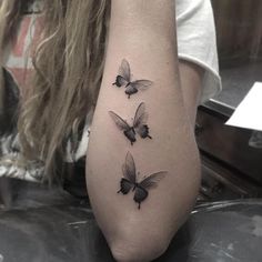 three butterflies tattoo on the left arm