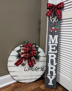 a wooden merry sign next to a door with a red bow on it's head