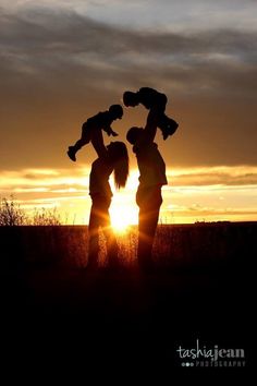 the silhouettes of two women and a baby are shown at sunset