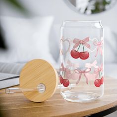 a glass vase sitting on top of a wooden table next to a paddle and mirror