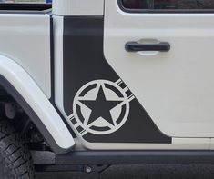 a white and black truck with a star on it's side window sticker