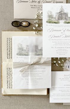 the wedding stationery is laid out on top of each other