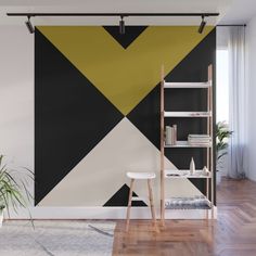 a living room with black, white and yellow geometric wallpaper mural in the corner