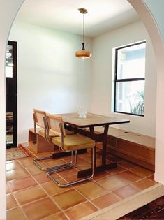 a dining room with a table and chairs