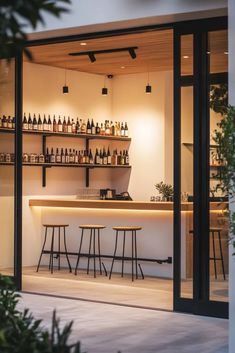 an outdoor bar with stools and bottles on the shelves