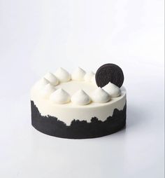 an oreo cookie on top of a white cake