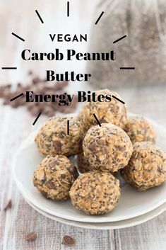 vegan carrot peanut butter energy bites on a white plate with chocolate chips in the background