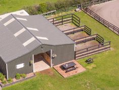 an aerial view of a horse barn