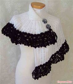 a white and black knitted shawl on a mannequin