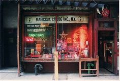 a store front with neon signs in the window and other items on display behind it