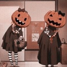 two women dressed in halloween costumes with pumpkins on their heads and holding purses