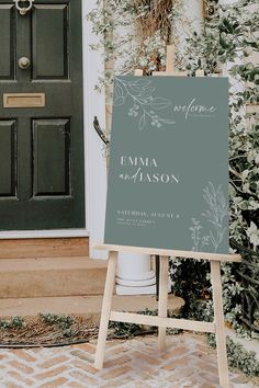 an easel stands in front of a door with a sign that reads,'emma and mason '