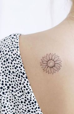 a woman with a small sunflower tattoo on her back