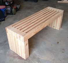 a bench made out of wooden slats in a garage