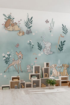 the wallpaper in this children's room is painted with animals and plants