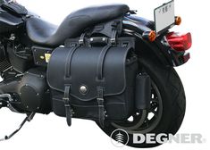 a black motorcycle with a leather bag on the back