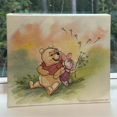 a winnie the pooh and piglet card sitting on a window sill