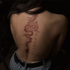 a woman with a dragon tattoo on her back