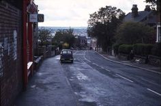 an old car is parked on the street