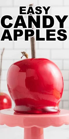 an apple sitting on top of a cake stand with the words easy candy apples above it