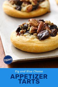 appetizer tarts with figs and blue cheese in the middle on a baking sheet