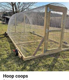 a chicken coop is shown in the grass