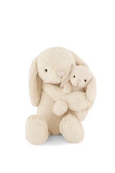 a white stuffed animal with two smaller ones in it's arms on a white background