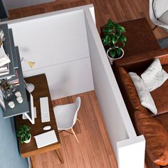 an overhead view of a living room with couches, coffee table and computer desk