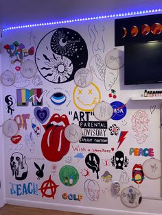 a wall covered in lots of different kinds of stickers and magnets on it