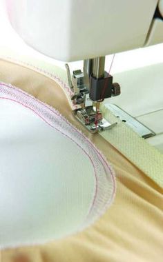 the sewing machine is working on the fabric that has been stitched together with it's needle