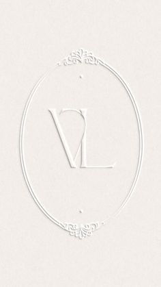 a white logo with the letter v in it's center and an ornate frame around it