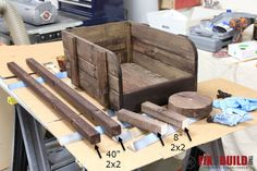 some wood is sitting on top of a workbench with measurements for the pieces