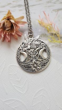 Wiccan FairyNecklace ☻Pendant ~ Round Silver ~ Triple Moon ~ With Magical Fairy ~ See Photos for size comparison against American quarter Chain: ~ Silver Plated YOU CHOOSE YOUR CHAIN LENGTH during checkout ☻Link to The ENTIRE SHOP: https://www.etsy.com/shop/FashionCrashJewelry?ref=shopsection_shophome_leftnav&ga_search_query=crystal%2Bnecklace Our Motto ~ Happy Customers Are Awesome Let us know of any problems or concerns with purchases. 5star reviews and positive comments are greatly appreciate Pocket Knife Necklace, Wiccan Necklace, Wiccan Magic, Fire Opal Necklace, Magical Fairy, Pagan Jewelry, Triple Moon, Chain Silver, Fantasy Jewelry