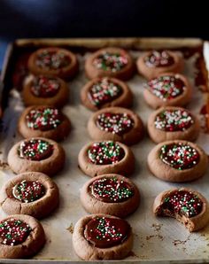 chocolate cookies with sprinkles are on a baking sheet, ready to be baked