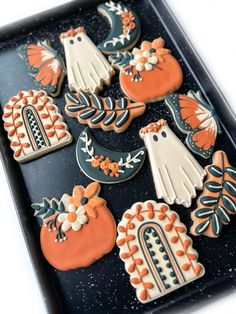 decorated cookies are arranged on a tray