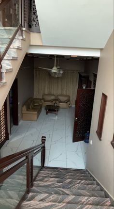 an overhead view of a living room with stairs leading up to the second floor area