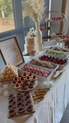 a table topped with lots of different types of desserts