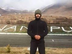 a man standing in front of a parking lot