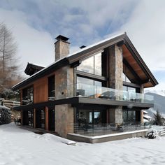 a large house in the snow with lots of windows