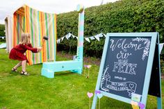 a chalkboard sign in the middle of a lawn