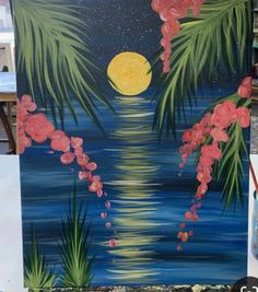 an easel painted with flowers and palm trees in front of a full moon at night