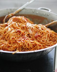 a pan filled with spaghetti on top of a stove