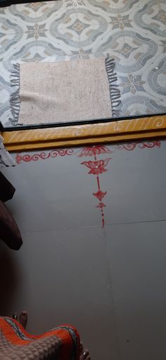 someone is painting the floor with red paint on it and there are other things in the room