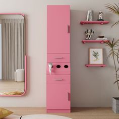 a pink cabinet in the corner of a room with a mirror and plant on it