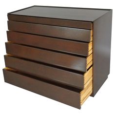 four drawers are stacked on top of each other in this modern style drawer unit that is made out of wood