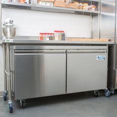 an industrial kitchen with stainless steel cabinets and shelves