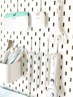 the toothbrushes are hanging on the pegboard