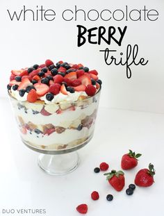 a white chocolate berry trifle with strawberries and blueberries