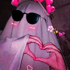 a ghost with sunglasses making a heart shape